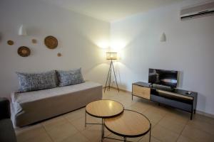 a living room with a couch and a table at Aquamar Albufeira Aparthotel in Albufeira