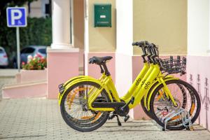a yellow bike parked in front of a building at Aquamar Albufeira Aparthotel in Albufeira