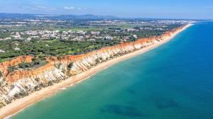 an aerial view of a beach and the ocean at Aquamar Albufeira Aparthotel in Albufeira