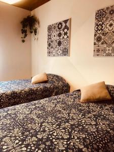 twee bedden naast elkaar in een kamer bij Mojo House in Ribeira Grande