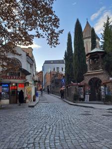 a cobblestone street in the middle of a city at Apartment on Xancteli in Tbilisi City