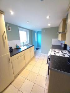 a kitchen with a sink and a stove top oven at 2 Well St in Llanberis