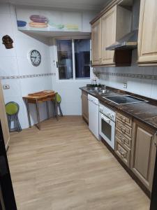 a kitchen with a stove and a table in it at Vigo Excursions in Vigo