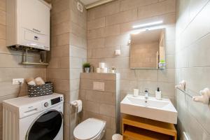 a small bathroom with a washing machine and a sink at Flexible SelfCheckIns 39 - Zagreb - Parking - New in Zagreb +18 photos