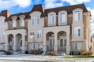a large brick house with a brown roof at Modern 4 Level home-Game room/Parking/Near Airport in Mississauga