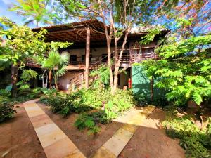a house with a garden in front of it at Villa Valencia in Jericoacoara