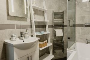 a bathroom with a sink and a toilet and a shower at The Sea Deck Apartment - Westbrook Bay Beach - By Goldex Coastal Breaks in Kent