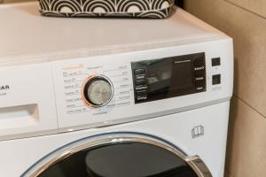 a white washer and dryer sitting on a counter at Flexible SelfCheckIns 39 - Zagreb - Parking - New in Zagreb