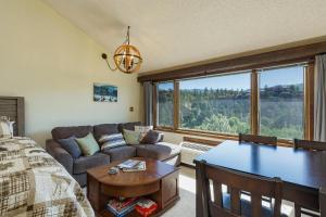 a bedroom with a bed and a couch and a table at Tamarron Lodge Studio - 406 in Durango