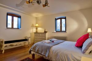 a bedroom with a bed and a bench and windows at Luxury Stamford Centre Apartment 2Bed - The Old Seed Mill C in Stamford