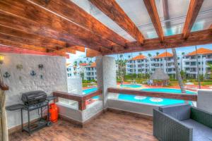 un patio avec un grill et une piscine dans l'établissement Ultra Cosy 2 Bedroom Beach Apartment - K-302, à Punta Cana