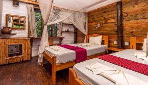 a bedroom with two beds and a fireplace at Miseni Retreat in Bagamoyo