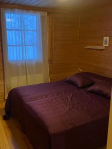 - une chambre avec un grand lit et une fenêtre dans l'établissement Panoraama 1, à Saariselka