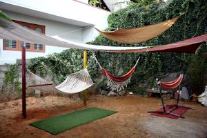 a group of hammocks hanging from a building at Cornwall for Couple in Madikeri