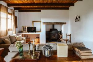 a living room with a couch and a fireplace at LOS TILOS Casa rural en el campo. in Tordera