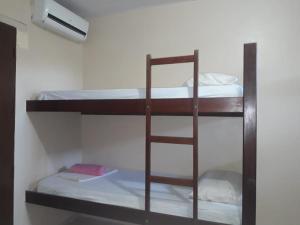 a group of bunk beds in a room at Pousada Village Maçarico in Salinópolis