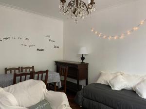 1 dormitorio con cama, mesa y lámpara de araña en Casa MAR DEL PLATA. Zona Guemes - Playa Grande en Mar del Plata
