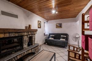 a living room with a couch and a fireplace at Pentone in Cervione