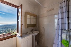 a bathroom with a sink and a window at Pentone in Cervione