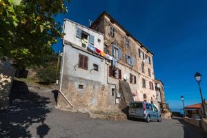 a car parked in front of an old building at Pentone in Cervione