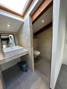 a bathroom with a sink and a toilet at Villa Colombo in Bonifacio