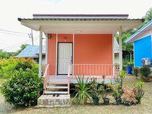 a house with a porch and stairs to it at TR Bungalow in Ban Tha Rua