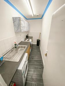 a small kitchen with a sink and a stove at 2 Bed Central Hub in Medway in Chatham