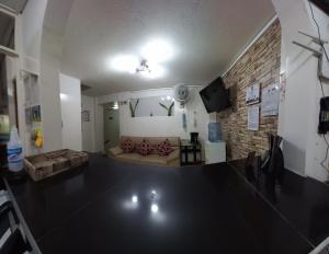 a living room with a couch and a brick wall at Hotel Santa Teresita in Yopal