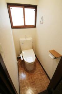 a bathroom with a toilet with a window above it at TsukisamuFukuya / Vacation STAY 2141 in Sapporo
