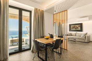 a living room with a table and chairs and a couch at Mani Theasis in Stoupa