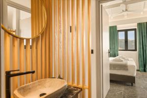 a bathroom with a sink and a bed at Mani Theasis in Stoupa