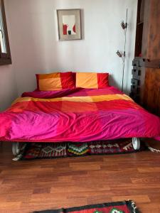 um quarto com uma cama com um cobertor colorido em Appartamento + box a Cervinia con vista em Breuil-Cervinia