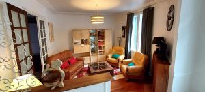 una sala de estar con sillones de cuero y sillas en Gîte Le Valette en Tulle