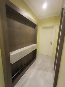 an empty room with a large shelf and a door at Apartament Tzar Kaloyan in Burgas