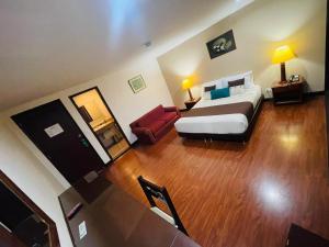 a hotel room with a bed and a couch at Hotel La Sabana in Bogotá
