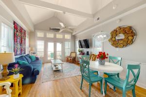 a living room with a blue couch and a table at Happy Days in St. George Island