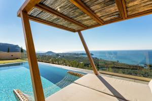 a view from a villa with a swimming pool at Mani Theasis in Stoupa