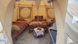 a room with two beds in a tent at glamping in Dromineer in Dromineer