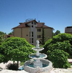 a white fountain in front of a building at Brilliance in Varna City