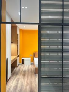 a room with yellow walls and glass doors at Ташкент сити in Tashkent +22 photos