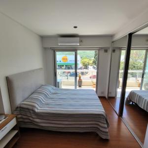 Schlafzimmer mit einem Bett und Glasschiebetüren in der Unterkunft Salta Hills in Salta