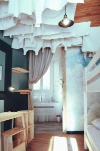 a bedroom with a ceiling with a mural of clouds at Eau Berges - Chez Mamie in Vicdessos