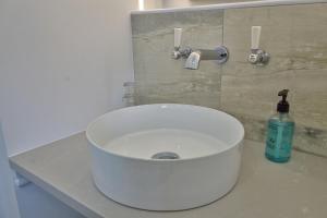 a white sink in a bathroom with a bottle of soap at The Tannochbrae in Dufftown