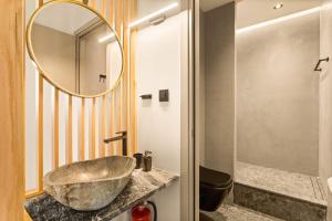 a bathroom with a sink and a mirror at Mani Theasis in Stoupa