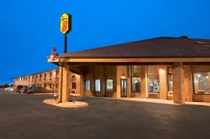 a building with a sign in a parking lot at Super 8 by Wyndham Green Bay I-43 Bus. Park in Green Bay