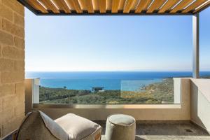 a room with a large window with a view of the ocean at Mani Theasis in Stoupa