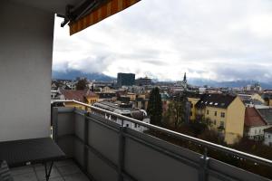 a view of a city from a balcony with a train at Downtown Klagenfurt Oasis in Klagenfurt