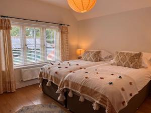a bedroom with a large bed and a window at Grange Farm in Lincolnshire