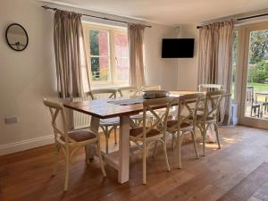 a dining room with a wooden table and chairs at Grange Farm in Lincolnshire