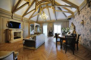 a living room with a couch and a table at Złota Łania Wiartel Resort & SPA in Wiartel